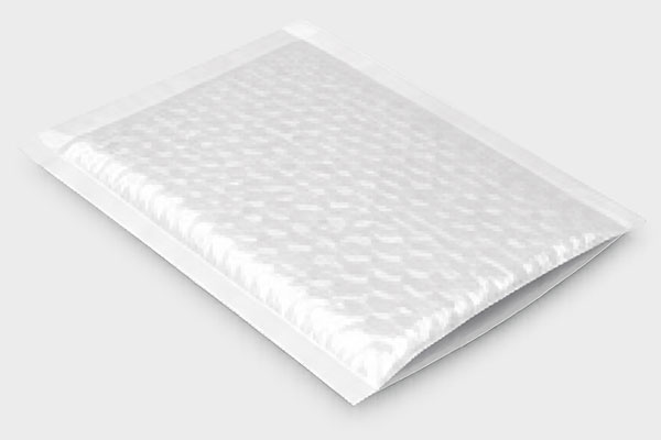 White padded mailer on a light gray background with an open flap and visible bubble wrap texture.