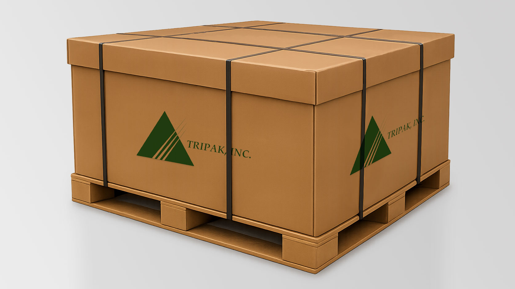 A large cardboard box secured with black straps on a wooden pallet, displaying the logo and text "TRIPAK, INC."