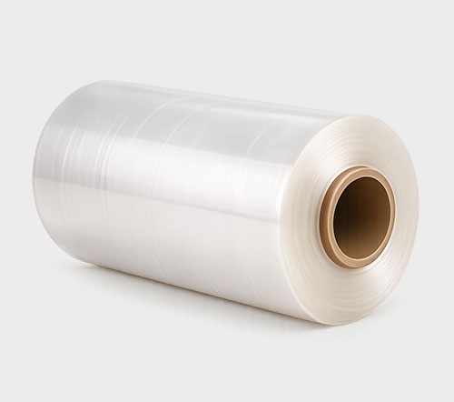 A large roll of clear plastic film with a cardboard core, set against a light gray background.