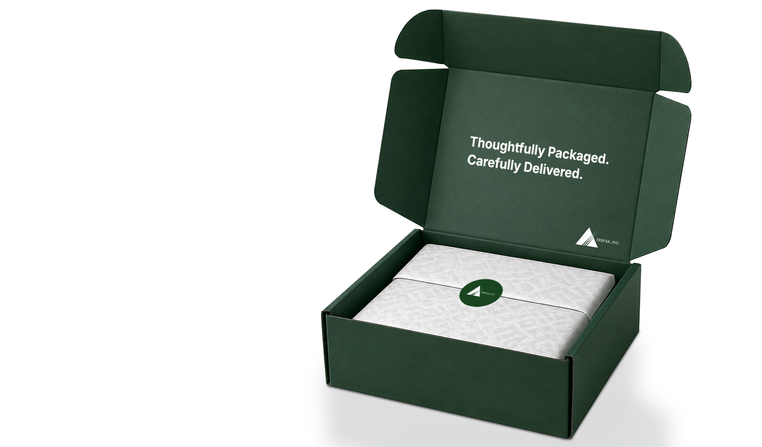 Open dark green box with white wrapped package inside, marked with a green sticker and text on the lid.