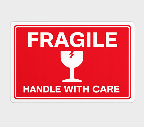 Handling Labels Red sign with the words "FRAGILE" and "HANDLE WITH CARE" above and below a broken wine glass icon.