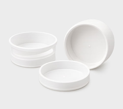 Three white cylindrical containers on a light gray background.