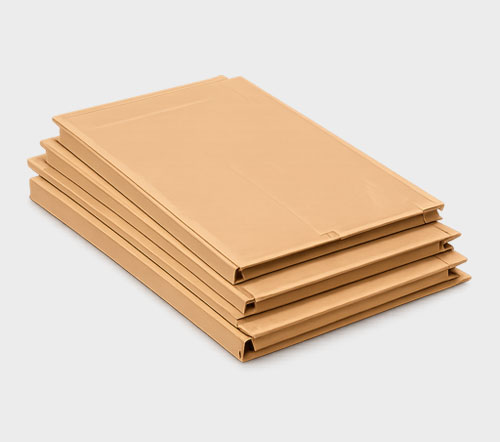 Stack of four brown cardboard envelopes on a gray background.