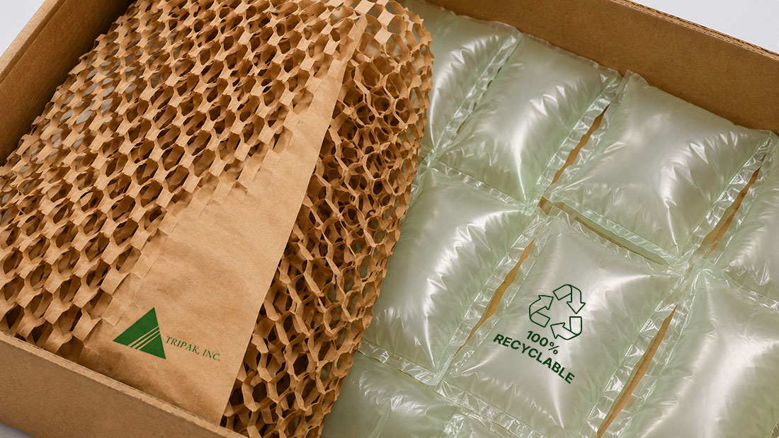 Void Fill Empty Space Cardboard box with honeycomb Kraft paper and air-filled plastic cushions labeled "100% Recyclable."