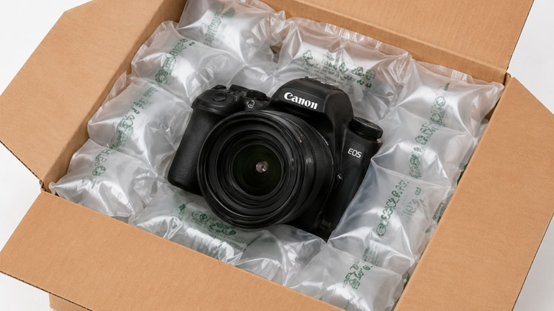 A Canon DSLR camera in a box with air pillows.