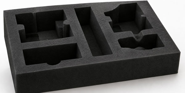 Black foam insert with multiple shaped cavities designed for holding objects securely.
