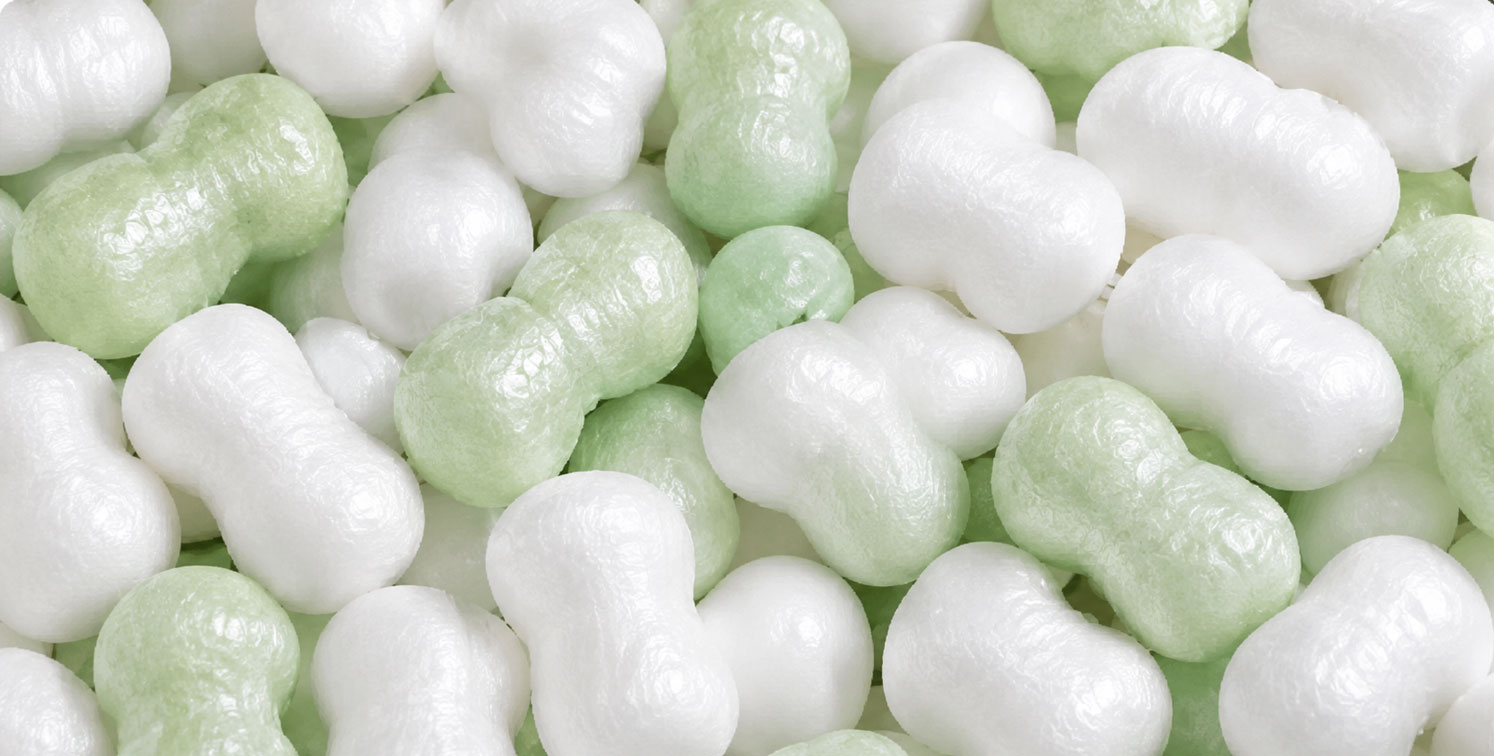 Close-up of white and light green packing peanuts.