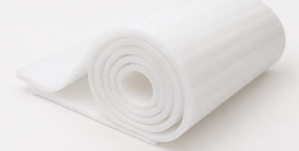 A rolled piece of white fabric-like material with visible layers.
