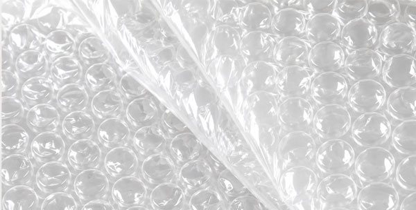 Multiple Bubble Sizes Close-up of transparent bubble wrap with folded section.