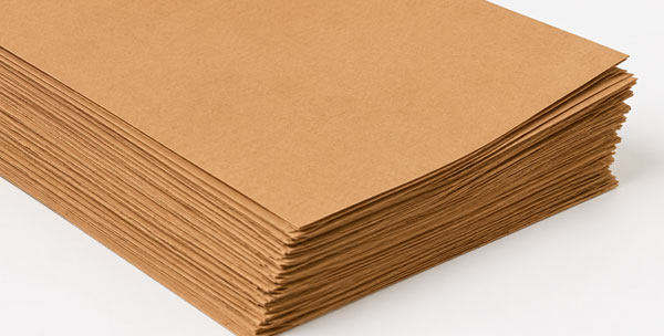 A stack of brown paper sheets on a white surface.