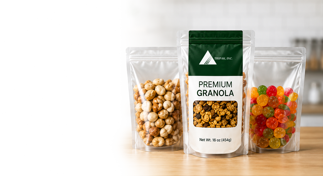 Three clear resealable bags filled with granola, nuts, and colorful candies on a wooden surface.