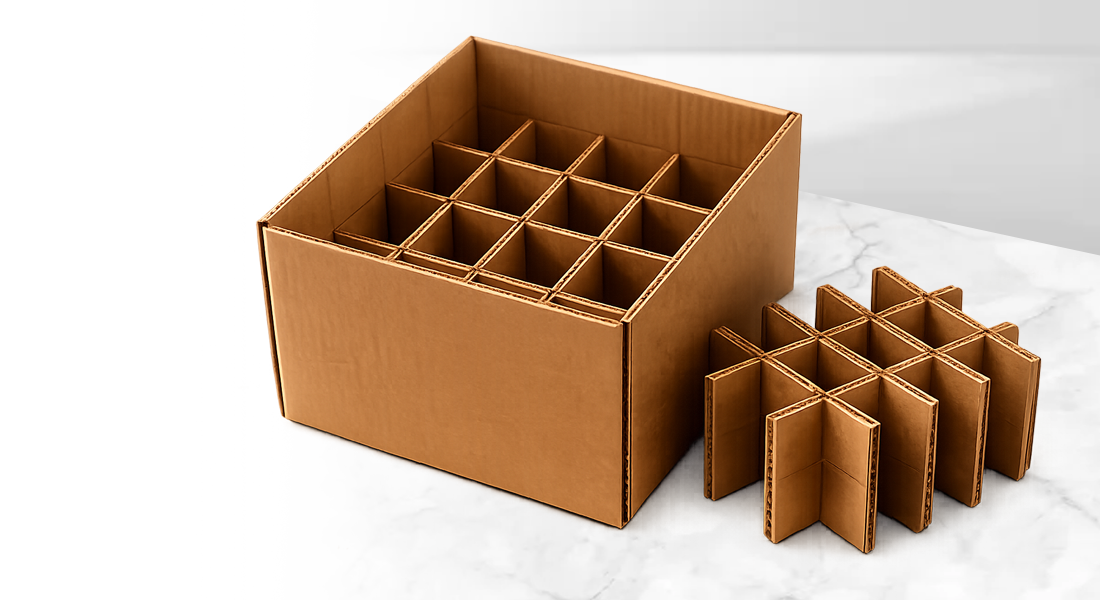 A cardboard box with grid dividers on a marble surface.