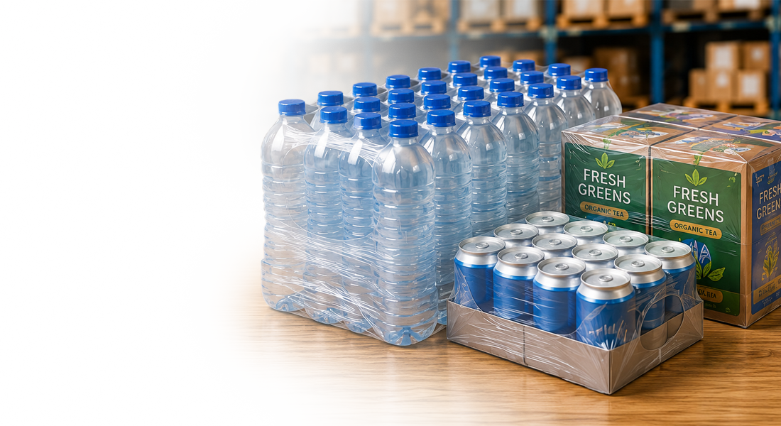 Packaged water bottles, aluminum cans, and boxes of "Fresh Greens Organic Tea" on a wooden surface.
