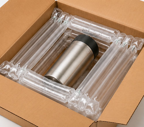 Suspended Packaging A metal tumbler inside inflatable packaging within a cardboard box.